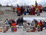 Mustang Lo Manthang Tiji Festival Day 3 09-2 Dorje Jono Final Attacks On Demon Father Dorje Jono takes a bow and arrow and shoots the demon, and then takes a slingshot and fires three rocks at the demon's remains. He then prays over each of the five pieces of demon and throws them on the ground in a heap. Finally Dorje Jono takes a tiger skin and flails the demon's remains. Finally he is satisfied that he has killed the demon and freed the people of Mustang from his death grip. Phew! Now that is hard work!